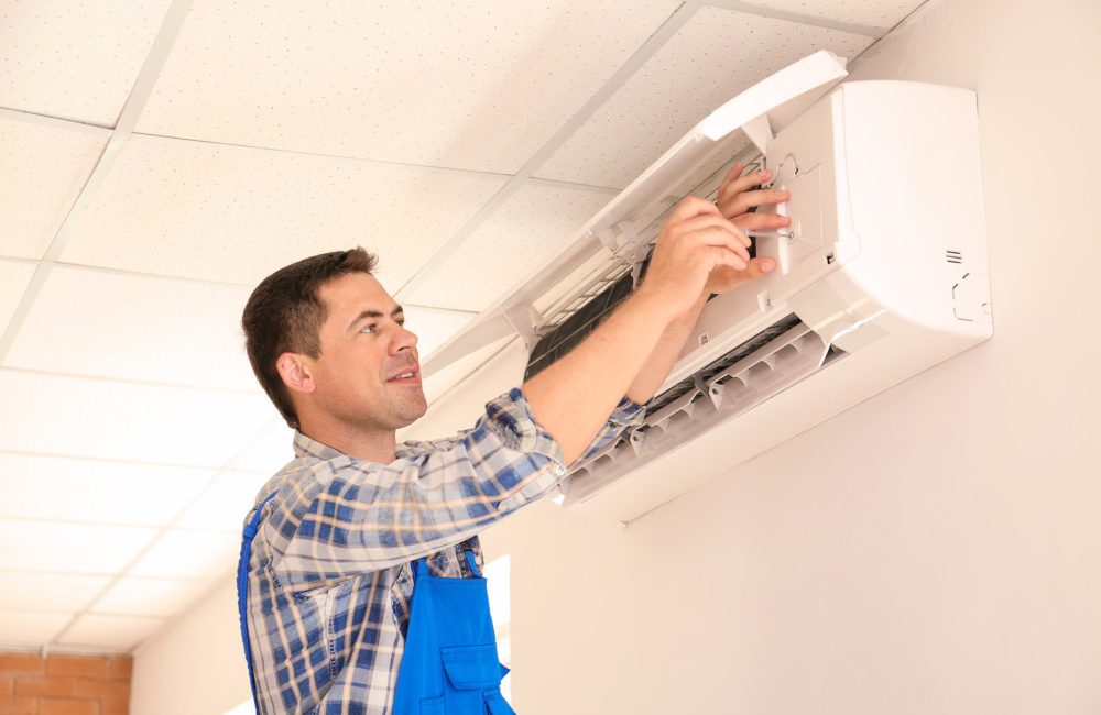 HVAC technician installing split wall-mounted air conditioner in Calgary – Shift Heating and Cooling Services