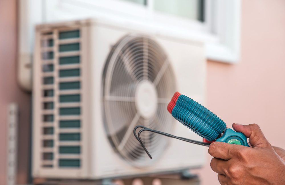 Technician performing maintenance on outdoor mini-split AC unit in Calgary – Shift Heating and Cooling Services