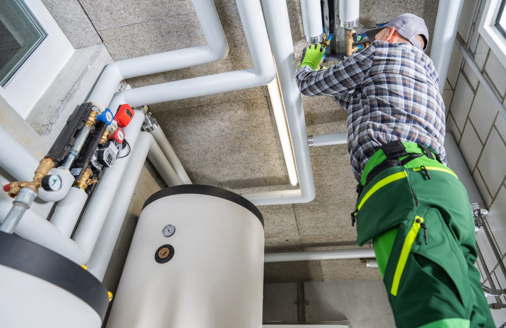 Technician servicing hydronic heating boiler and insulated piping system in Calgary – Shift Heating and Cooling Services