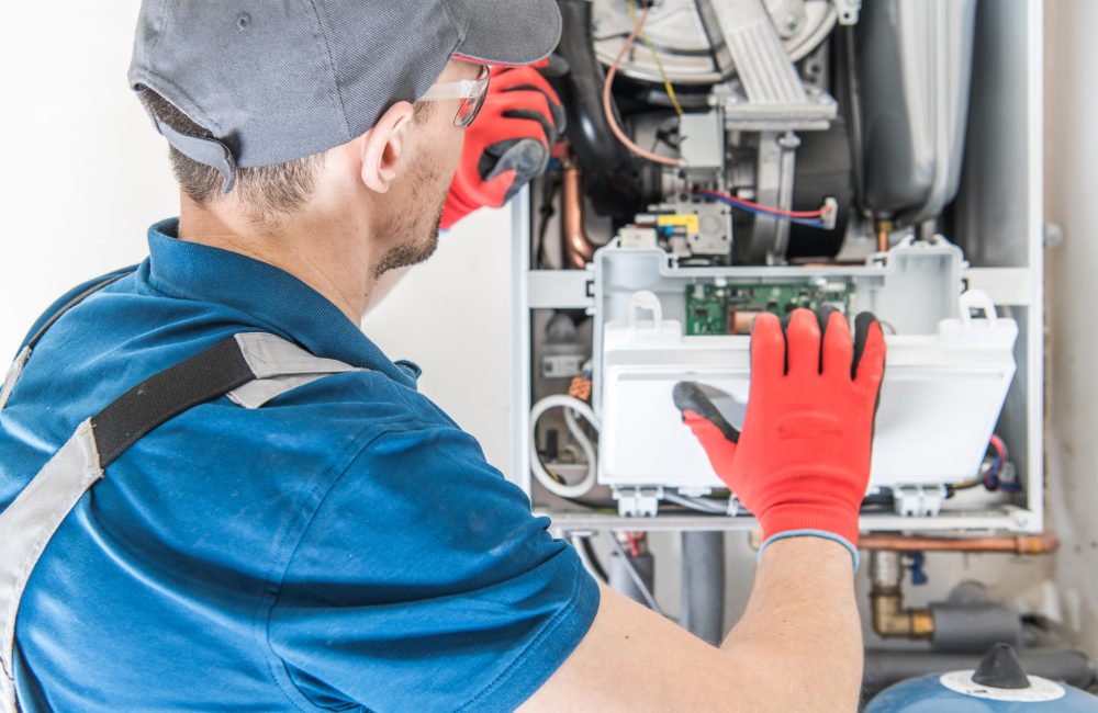 Calgary HVAC technician inspecting and servicing a boiler – professional boiler maintenance and repair services