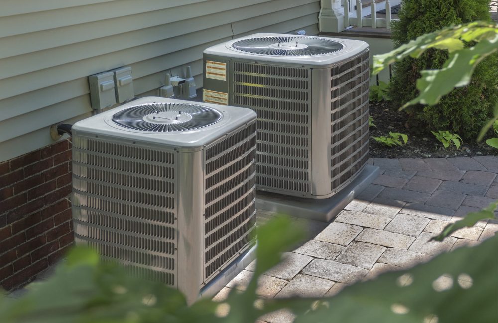 Dual central air conditioning units installed outside Calgary home – Shift Heating and Cooling Services