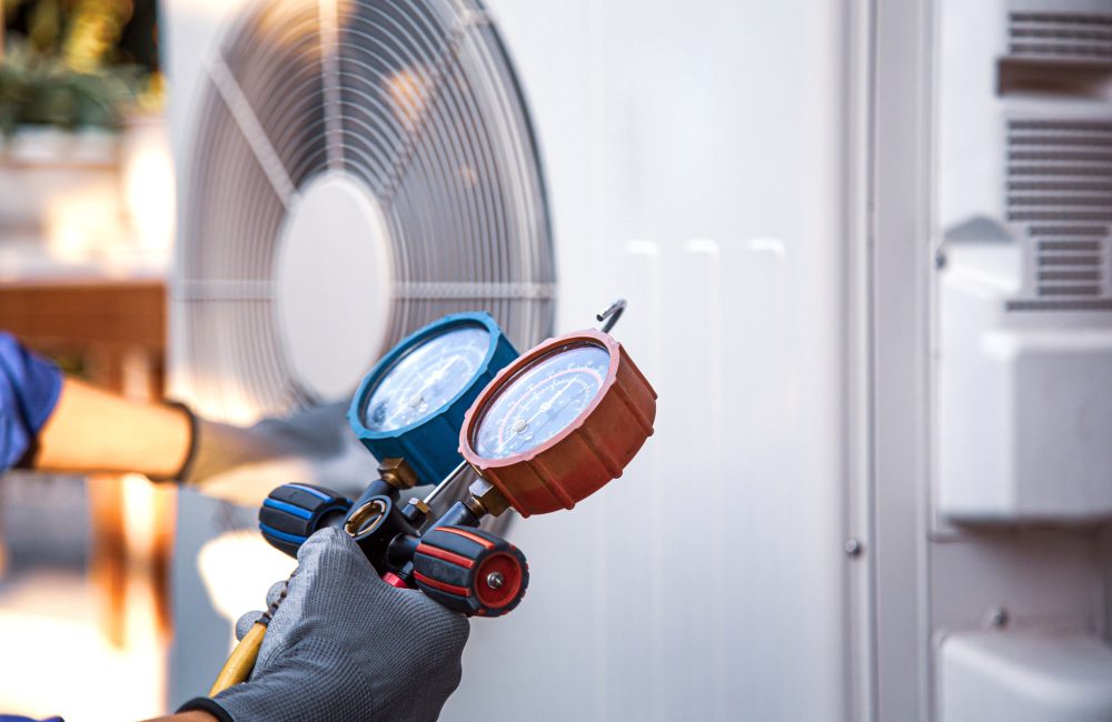 Calgary HVAC technician checks air conditioner refrigerant levels with manifold gauges – expert AC diagnostics by Shift Heating and Cooling Services