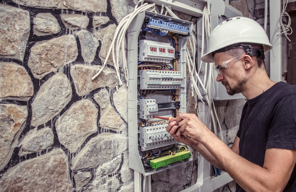 Calgary electrical technician wiring a home electrical panel – safe electrical installation and inspection by Shift Heating and Cooling Services